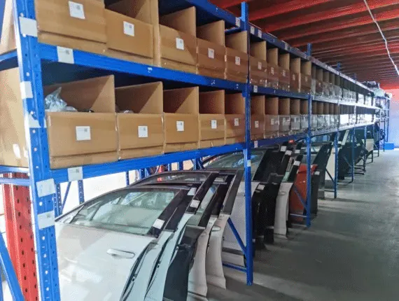 Used exterior parts and bumpers stored on warehouse racking